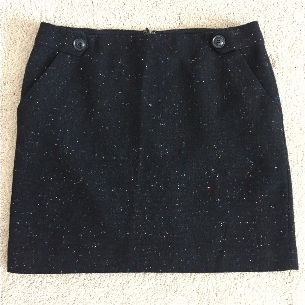Black skirt with slight pattern.